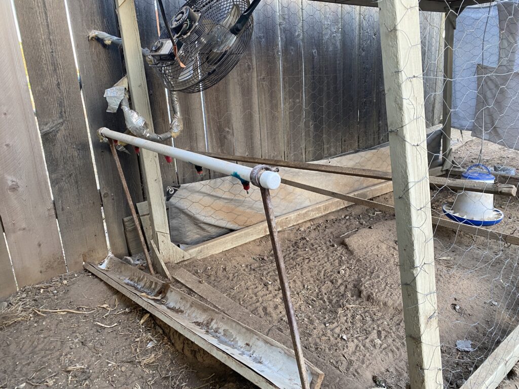 Horizontal PVC with chicken nipples over a drainage tray