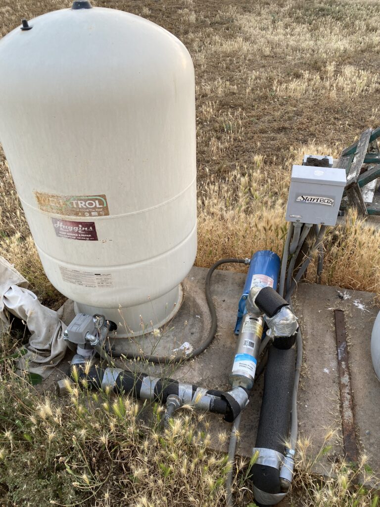 A bladder tank with tiny pressure switch, booster pump and control box